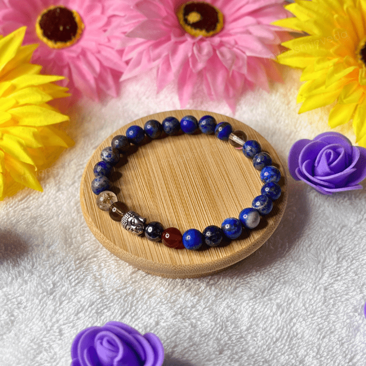Beaded bracelet on a wooden coaster with flowers in the background
