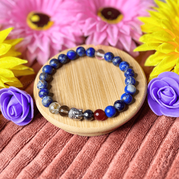 Beaded bracelet on a wooden coaster with flowers in the background