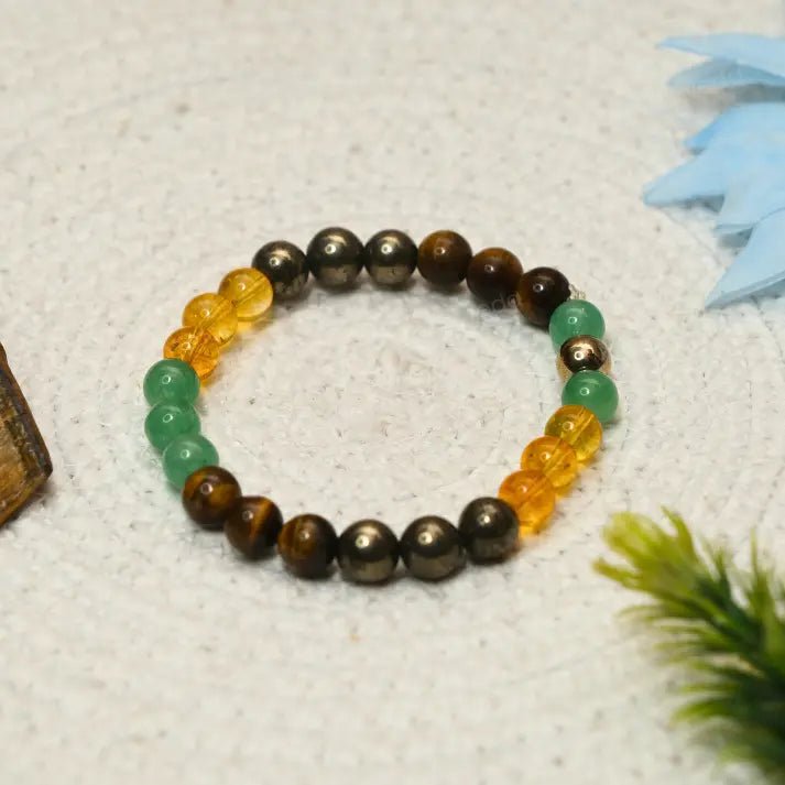 Multicoloured beaded Super_Money_Magnet bracelet on a textured surface with decorative elements.