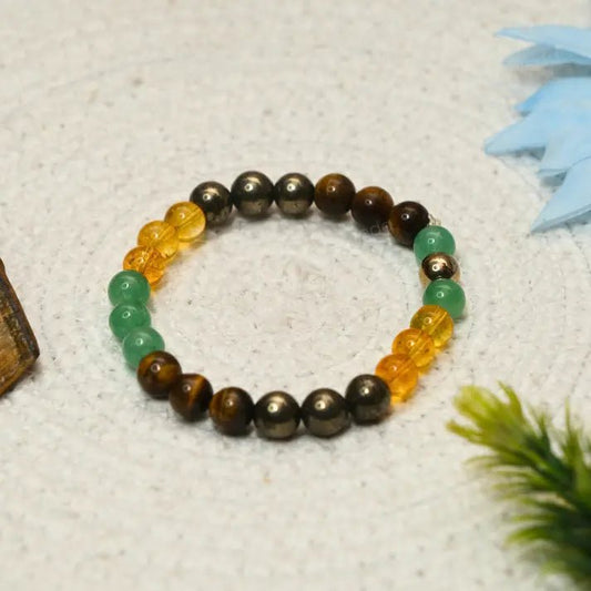 Multicoloured beaded Super_Money_Magnet bracelet on a textured surface with decorative elements.